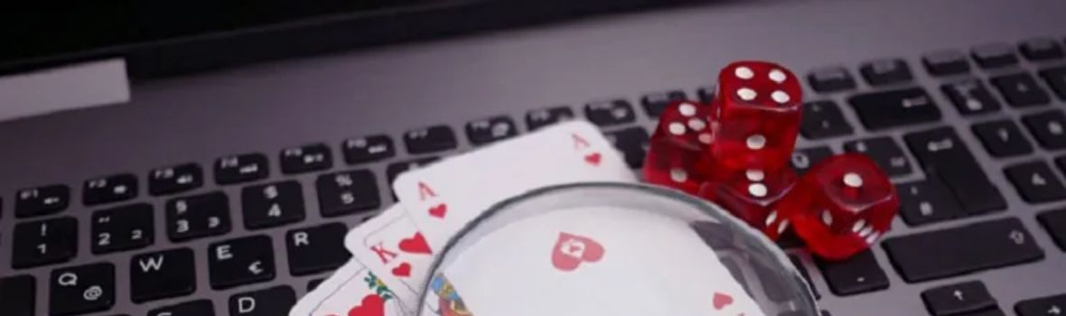 Playing cards and dice on a laptop